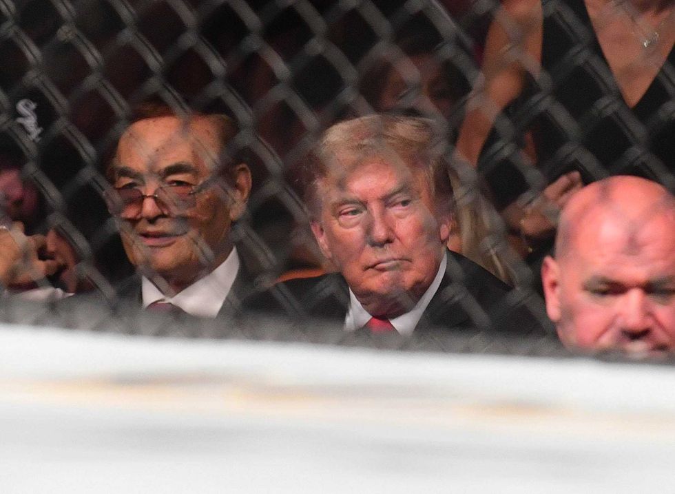 0Former US President Donald Trump attends UFC 264 at T-Mobile Arena in Las Vegas on July 10, 2021. To his lift is UFC