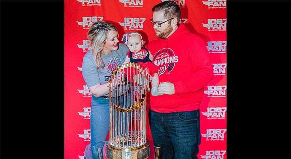 106.7 The Fan host Grant Paulsen and family pose with the World Series trophy