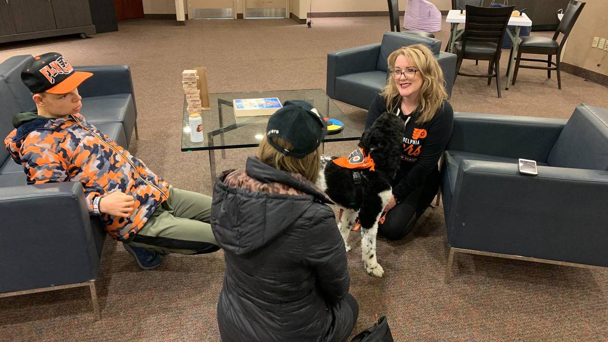 17-year-old Jack Stockmal (left) and his mother Carrie (middle), with neuropsychologist Jennifer West-Gavin and service companion dog Lullaby (right).