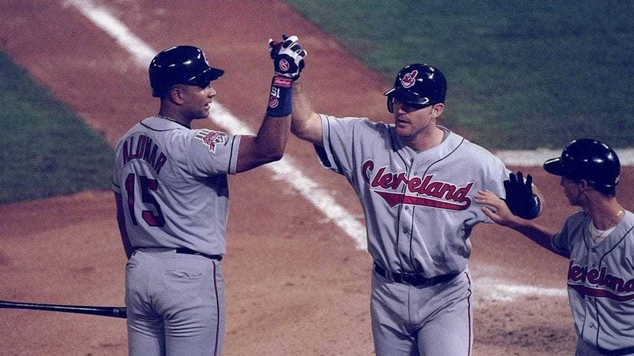 18 Oct 1997: First baseman Jim Thome and catcher Sandy Alomar of the Cleveland Indians high five each other during game one of the World Series against the Florida Marlins at Pro Player Park in Miami, Florida. The Marlins won the game 7-4.