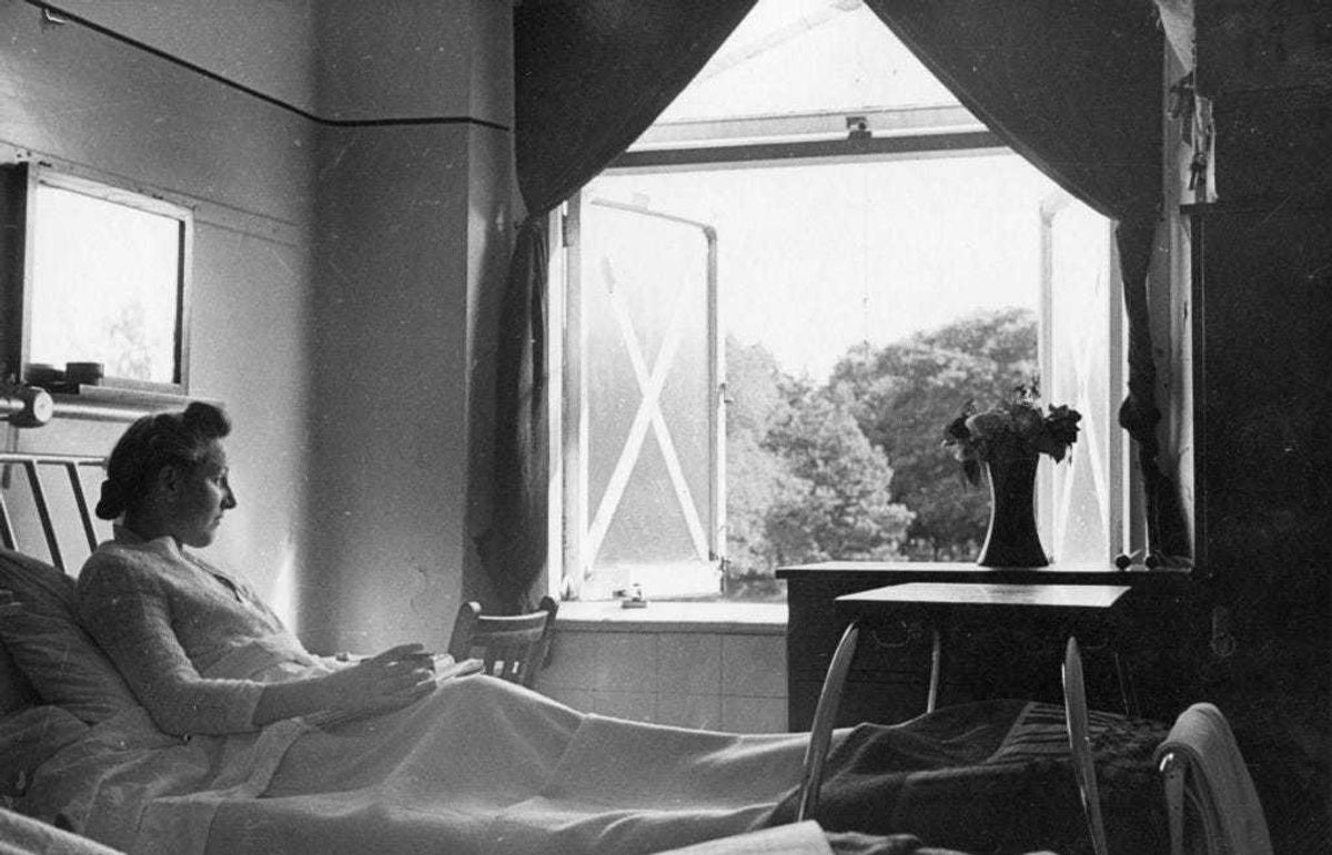 1942: A patient in the tuberculosis convalescent home at Paddington, London, enjoying the view from her window. (Photo by D. Hess/Fox Photos/Getty Images)