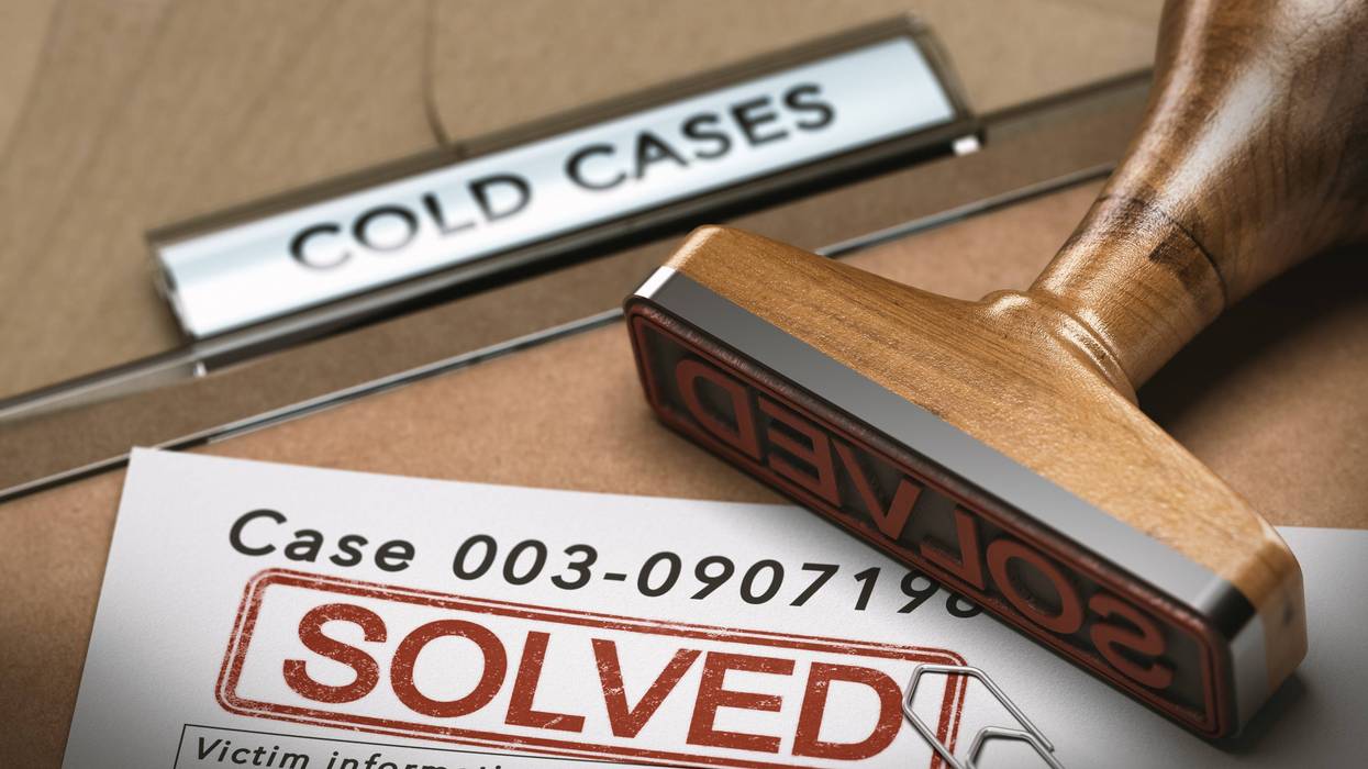 3D illustration of a cold case file with a rubber stamp and the word solved