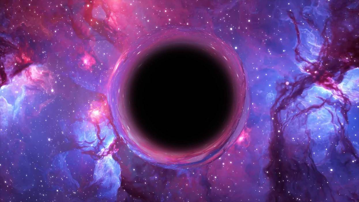 3D rendering of a supermassive black hole, in the foreground against a galaxy and starry sky