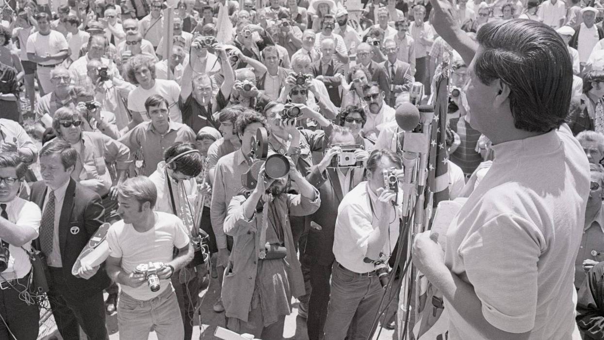 7/25/1970-San Rafael, CA- Cesar Chavez, director of the United Farm Workers Organizing Committee, gives victory sign to over one thousand members of various Northern California unions who staged a peaceful march against the San Rafael independent-Journal in support of the Typographical Union which has been on strike against the Bay Area newspaper for six months. Chavez addressed the crowd during rally at Albert Park and called for a non-violent boycott of the paper.