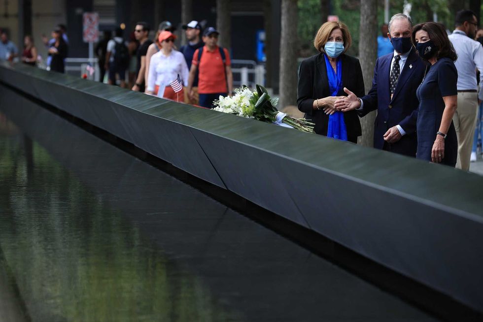 9/11 Memorial & Museum president Alice Greenwald (L) talks with Gov. Kathy Hochul (R) and former Mayor Mike Bloomberg after they laid flowers at the south memorial pool to commemorate the 20th anniversary of the September 11 terror attack on September 08, 2021