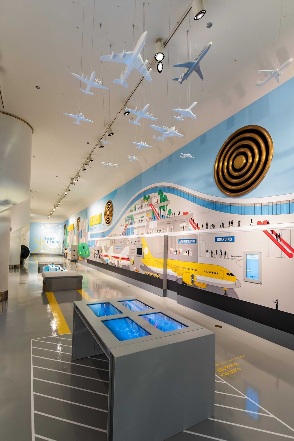 A 150-foot display takes guests on a behind-the-scenes journey from assembly to takeoff, while a "flock" of 25 models of influential airliners hangs overhead.