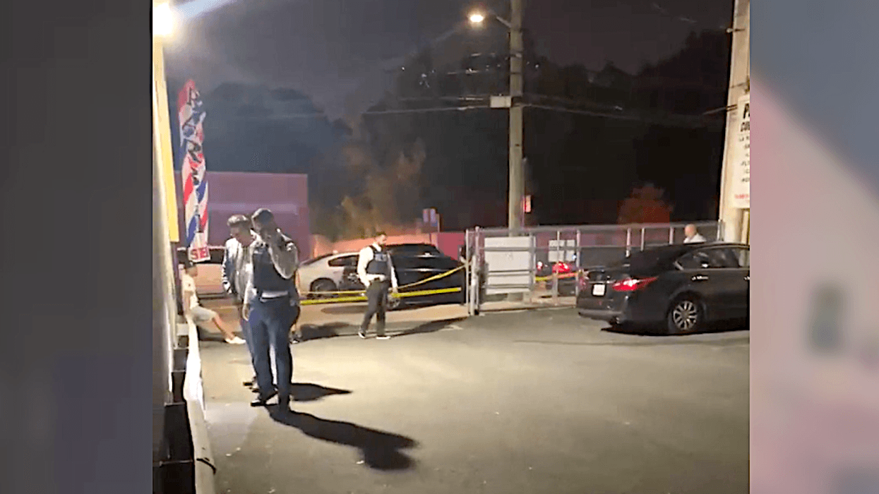 A 22-year-old woman was shot and wounded in a drive-by shooting on Staten Island Wednesday night. Detectives were seen searching the scene for evidence after the gunfire