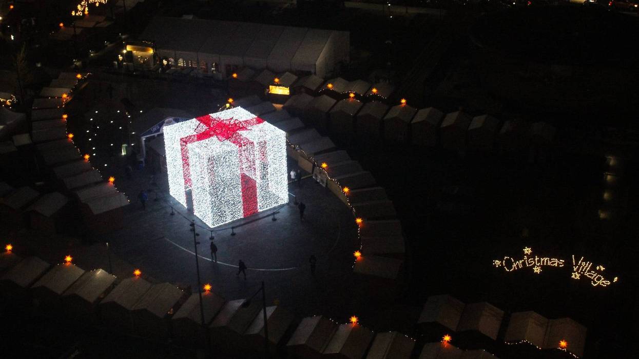 A 27-foot-tall Christmas present sits in the middle of the Christmas Village in LOVE Park.