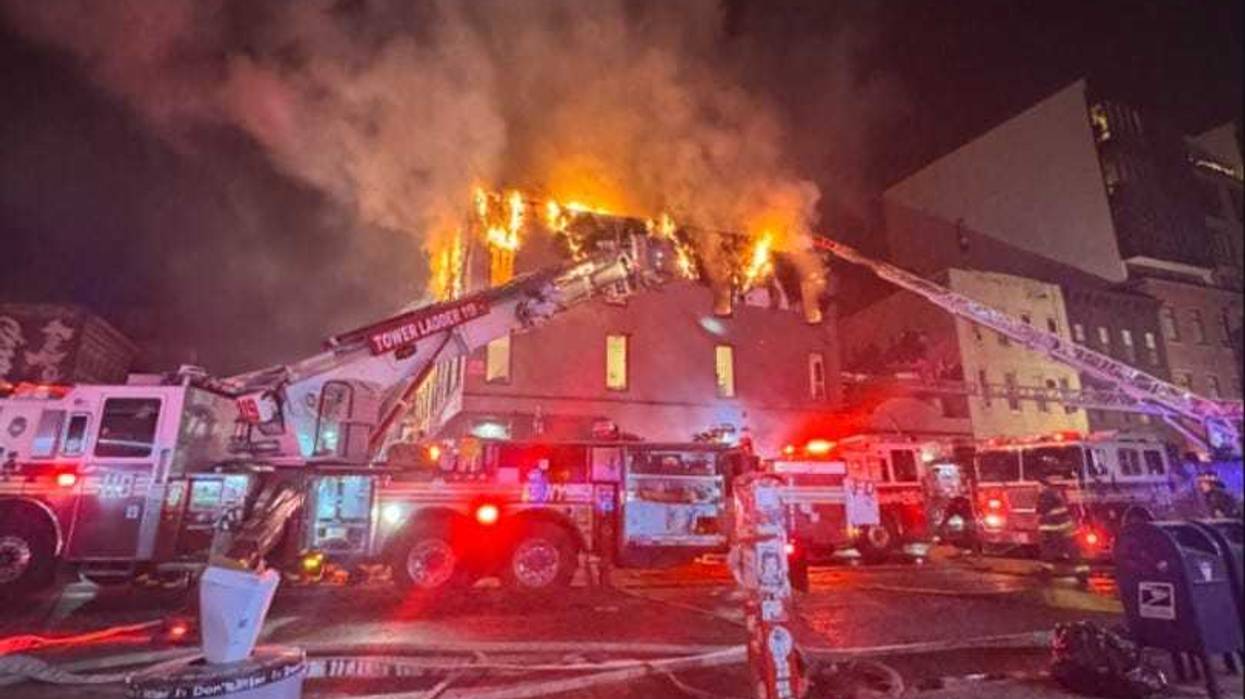 A 4-alarm fire burned at 335 Graham Ave. in Williamsburg, Brooklyn on Saturday night and extended to two adjoining buildings.