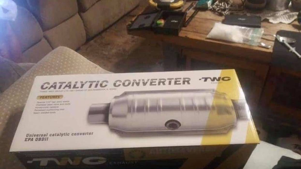 A bag of meth and a syringe are seen on a table in the background of photo