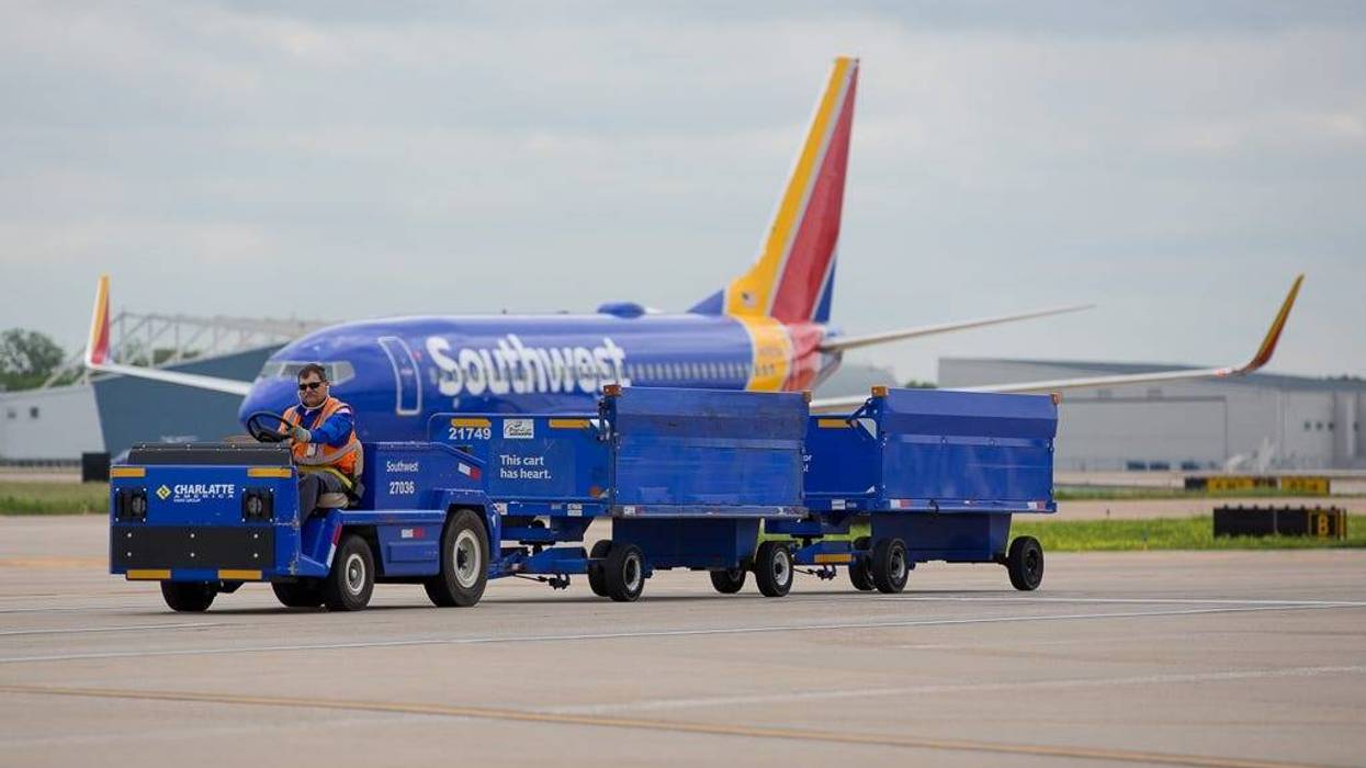 A baggage cart trundles across the ramp at Dallas Love Field on April 29, 2019.