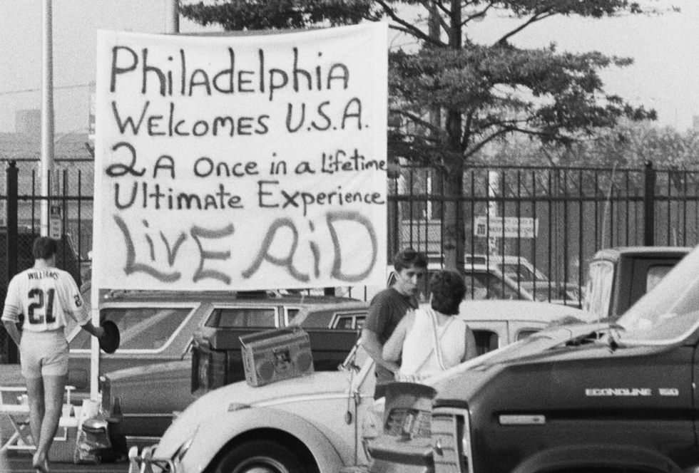 A banner reading "Philadelphia welcomes USA 2 a once in a lifetime ultimate experience," a reference to the city hosting the Live Aid benefit concert at John F. Kennedy Stadium in Philadelphia, Pennsylvania, July 13, 1985.