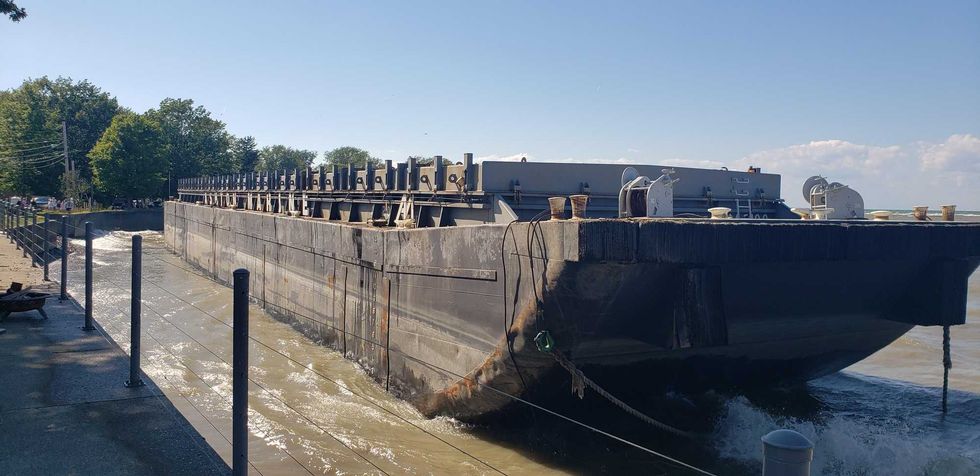 A barge being towed from Erie to Buffalo came loose overnight and is now beached at Van Buren Point near Dunkirk. The Coast Guard says the owner hopes to have it out tomorrow.