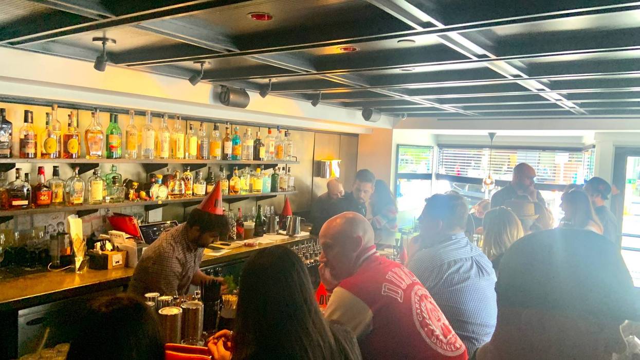 A bartender at a.bar in Rittenhouse sports a dunce cap for the launch of Dunce Bourbon Whiskey.