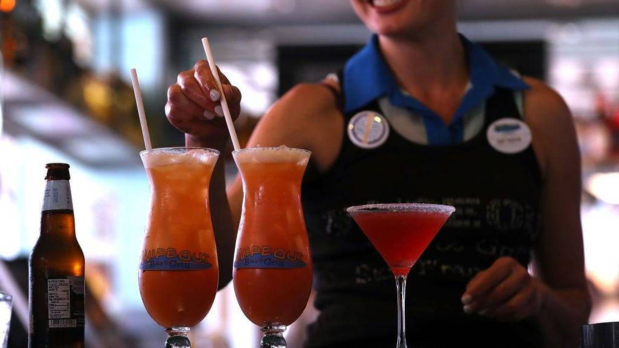 A bartender at Wipeout Bar & Grill makes cocktails that have paper straws on June 21, 2018 in San Francisco, California.