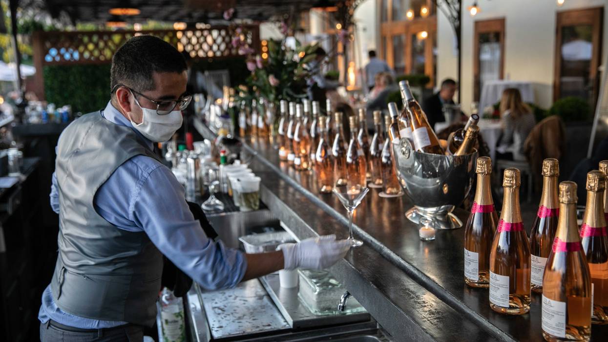 A bartender serves drinks at L'escale restaurant on May 20, 2020 in Greenwich, Connecticut.