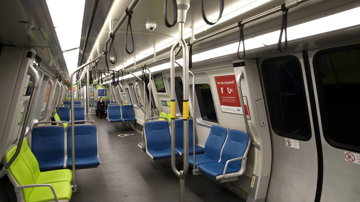 A Bay Area Rapid Transit (BART) passenger rides in an empty train car on April 08, 2020 in San Francisco, California. BART announced that it is slashing daily service as ridership falls dramatically due to the coronavirus shelter in place order.
