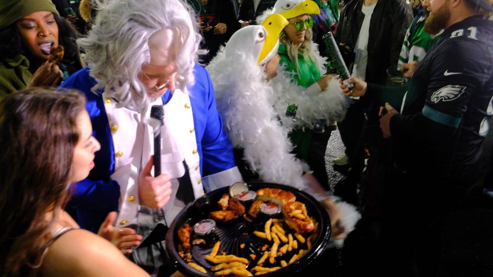 A "Ben Franklin" character holding snacks after the Philadelphia Eagles