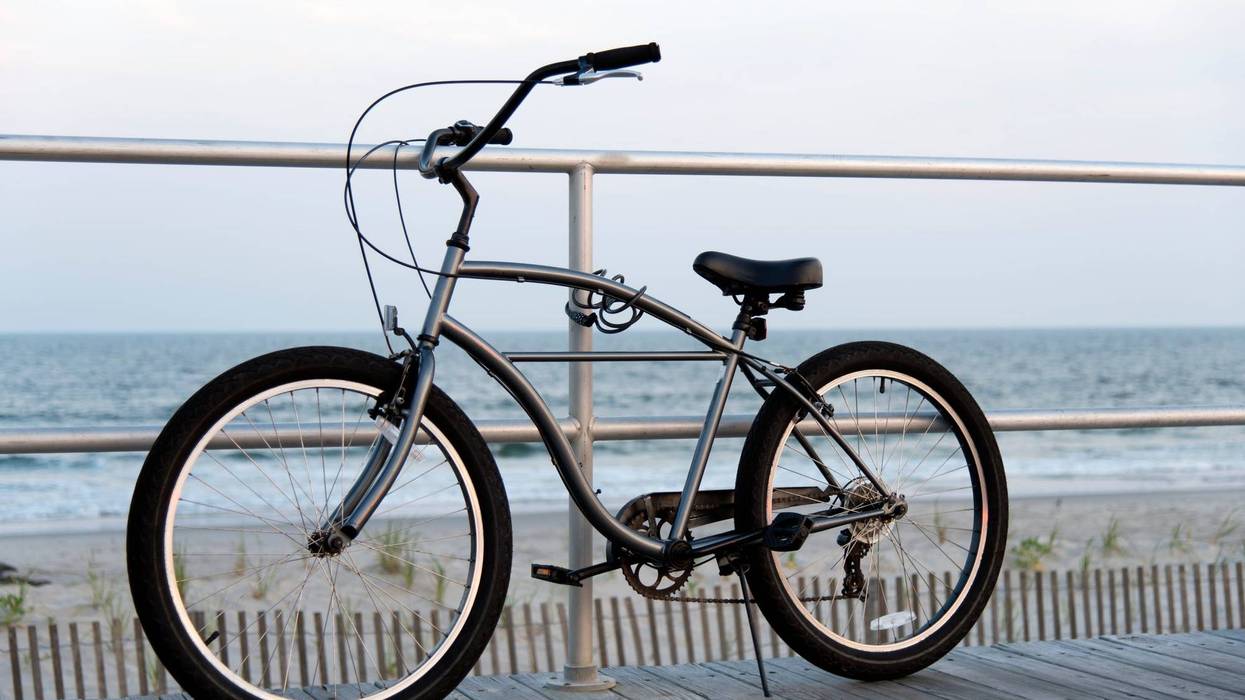 A bicycle chained to the Ocean City New Jersey Boardwalk overlooking the Atlantic ocean