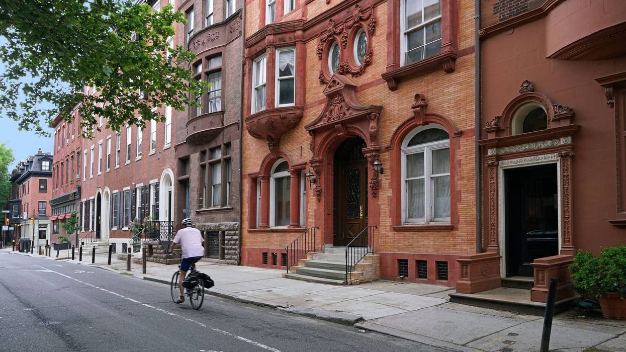 A bicyclist makes his way down a Philadelphia street.