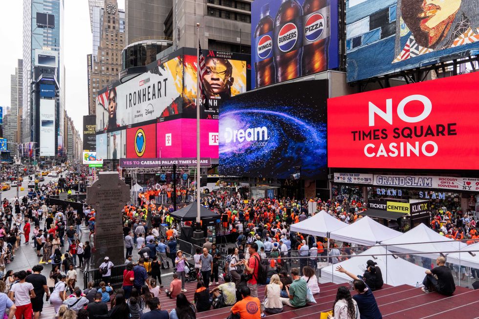 A billboard displays a message in opposition to a casino in Times Square