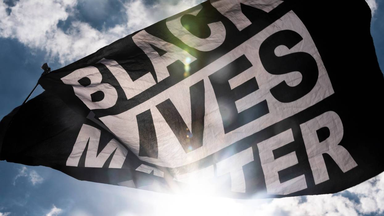 A Black Lives Matter flag waves during a demonstration.