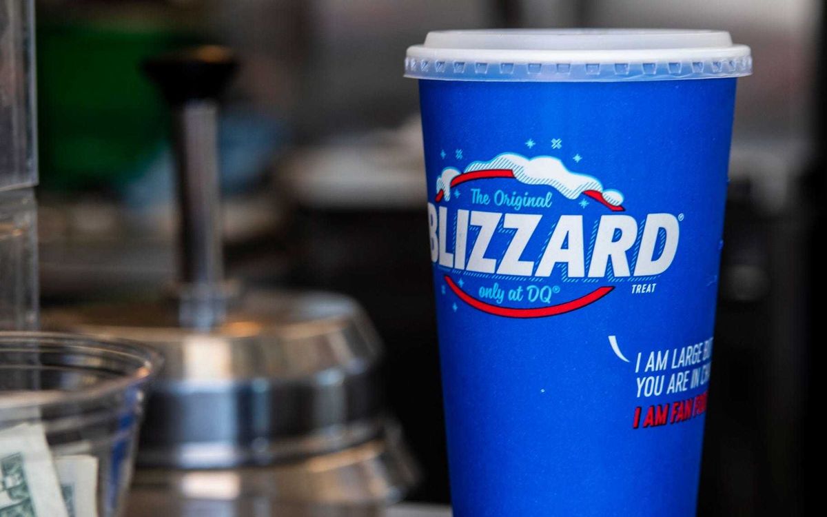 A Blizzard sits in a cup with a lid at a Dairy Queen