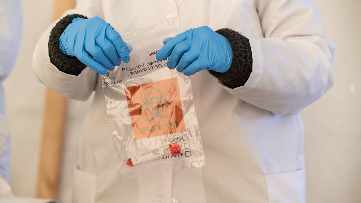 A Bluewater Diagnostic Laboratories technician bags up a completed nose swab test at a testing site at Churchill Downs on January 10, 2022 in Louisville,