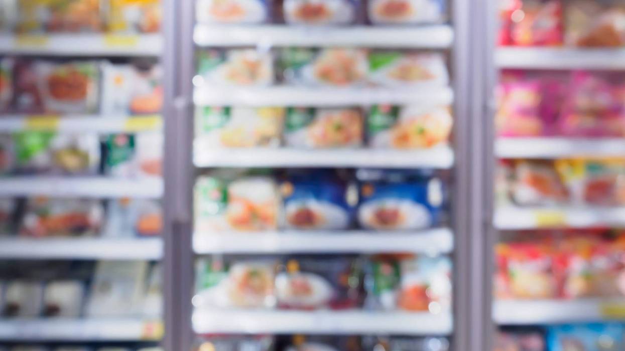 A blurry image of frozen foods in a supermarket.