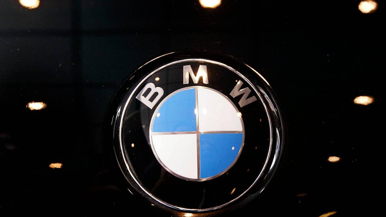 A BMW badge decorates the hood of a 330i.