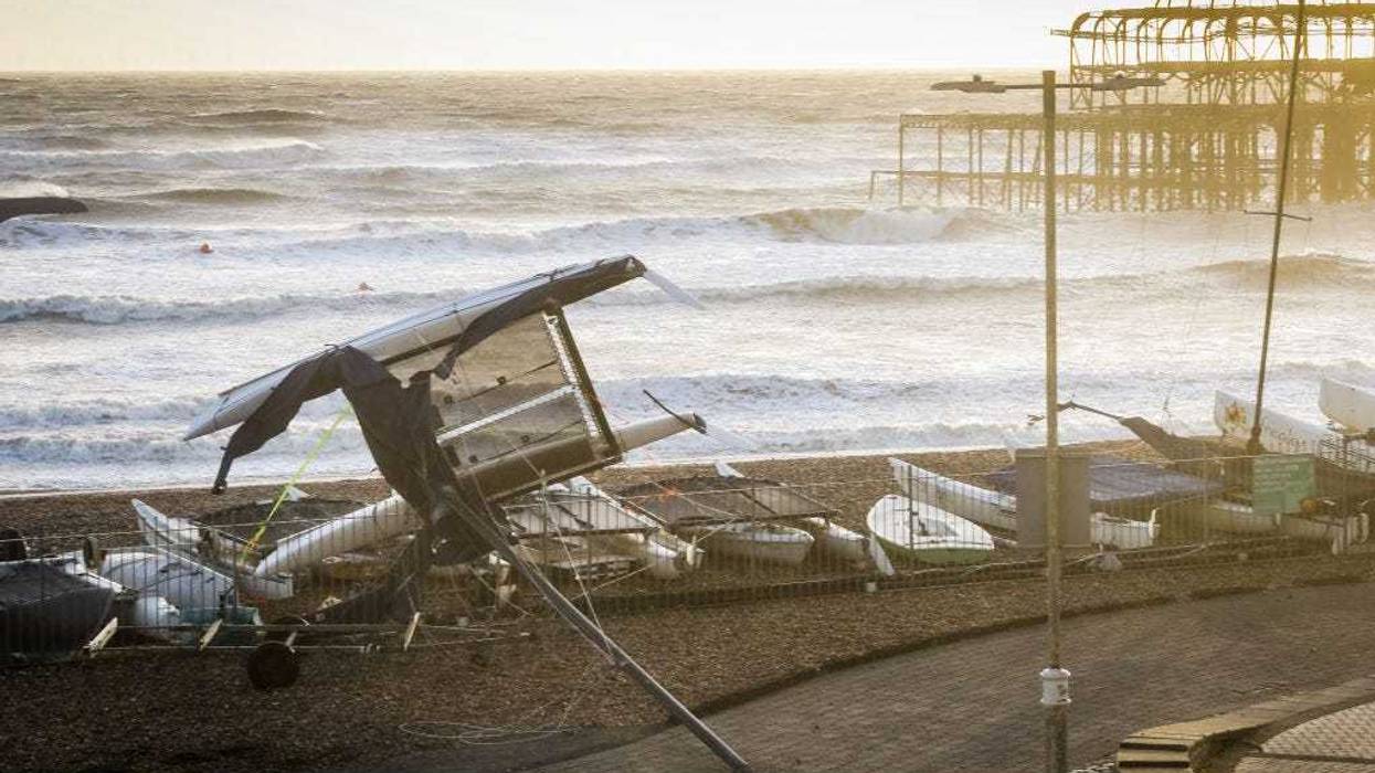 A boat is blown upside down on Brighton seafront on February 18, 2022 in Brighton, England. The Met Office has issued two rare, red weather warnings for the South and South West of England today as Storm Eunice makes landfall. Much of the rest of the UK is under amber and yellow warnings with winds up to 100 mph, rain and snow expected. This is the worst storm to hit the UK for three decades. (Photo by Tristan Fewings/Getty Images)