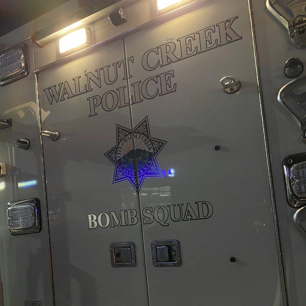 A bomb squad has shut down a station in Pleasant Hill after two people were allegedly found with an explosive device.