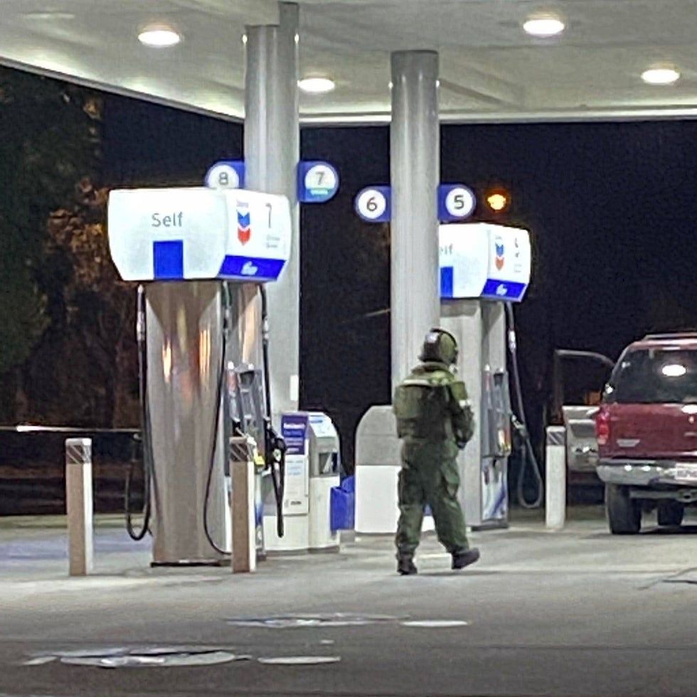 A bomb squad has shut down a station in Pleasant Hill after two people were allegedly found with an explosive device.