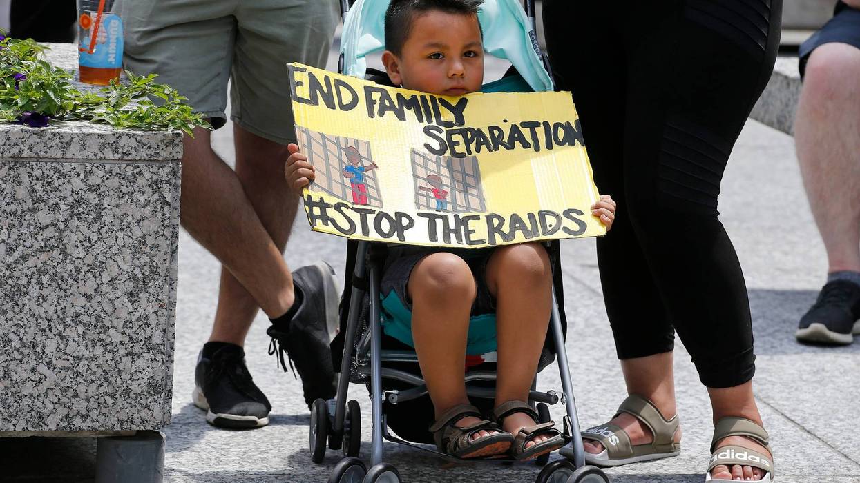 A boy holds a sign during a rally in Daley Plaza on July 13, 2019 in Chicago, Illinois. Protesters attended the rally calling for an end to criminalization, detention and deportations of migrants ahead of planned ICE raids expected to begin tomorrow.