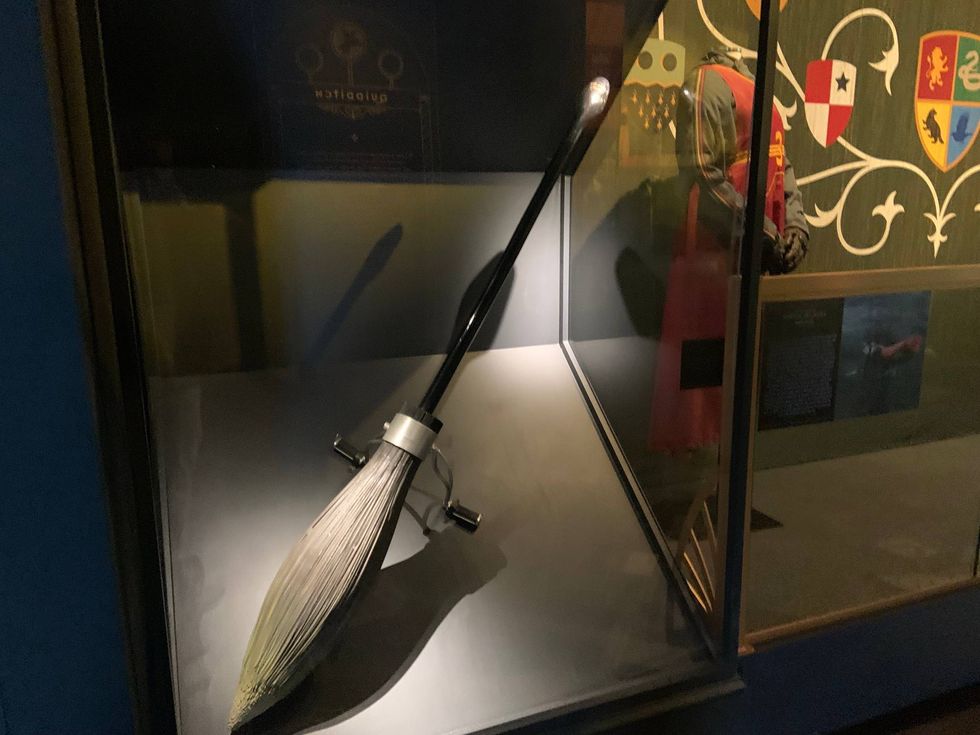 A broomstick and Quidditch player