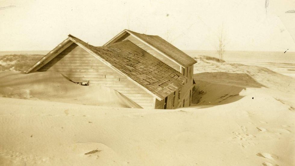 A building is almost completely buried beneath the sands of Singapore