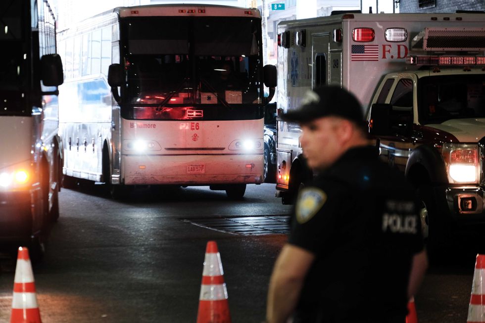 A bus carrying migrants who crossed the border from Mexico into Texas arrives at Port Authority bus station in Manhattan on Aug. 25, 2022