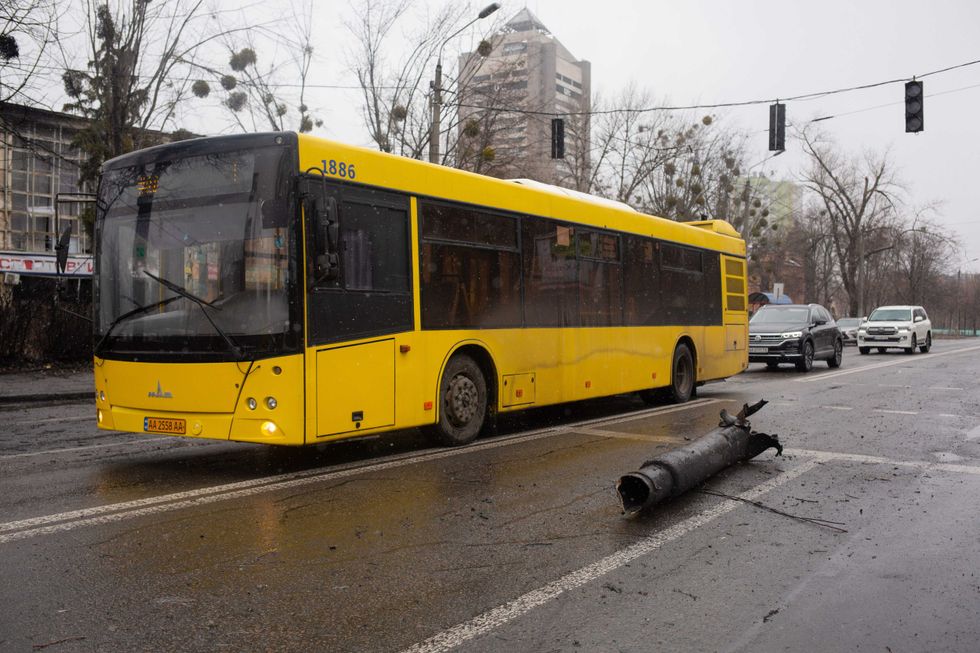 A bus drives by a shell debris on March 2, 2022 in Kyiv, Ukraine