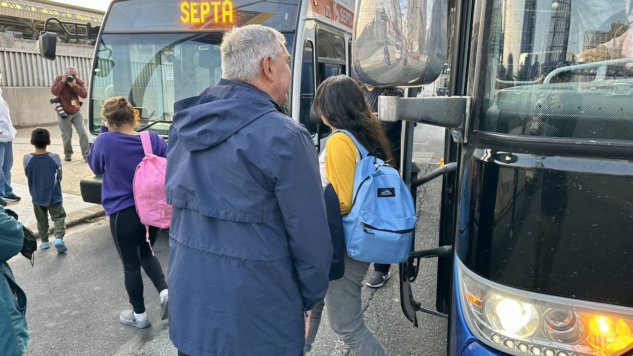A bus of migrants sent from Texas arrives at Philadelphia's 30th Street Station on May 10, 2023.