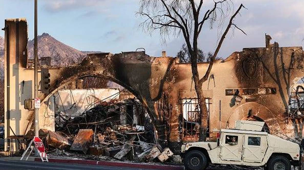 A California National Guard member looks out from a Humvee outside a building which burned in the Eaton Fire on January 17, 2025 in Altadena, California. Multiple wildfires which were fueled by intense Santa Ana Winds have burned across Los Angeles County leaving at least 27 dead with over 180,000 people having been under evacuation orders. Over 12,000 structures have been burned in the Palisades and Eaton Fires. (Photo by Mario Tama/Getty Images)