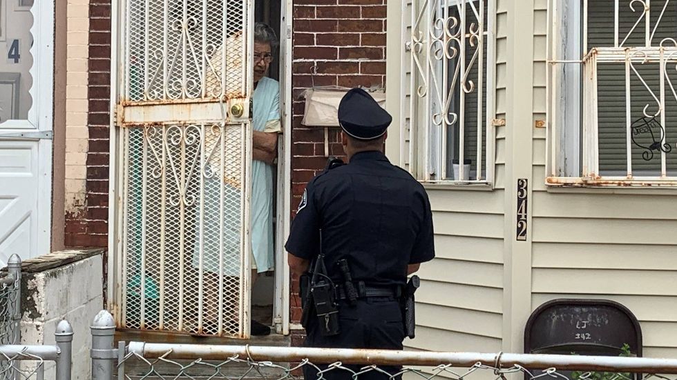 A Camden County police officer talked with a resident at her home after being sworn in Tuesday.