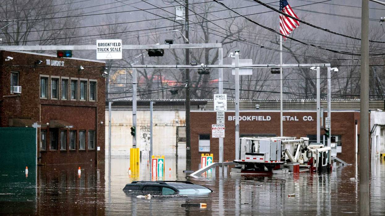 A car and a fire truck are submerged in flood water on Lamont Street in Elmsford, New York, on Dec. 18, 2023