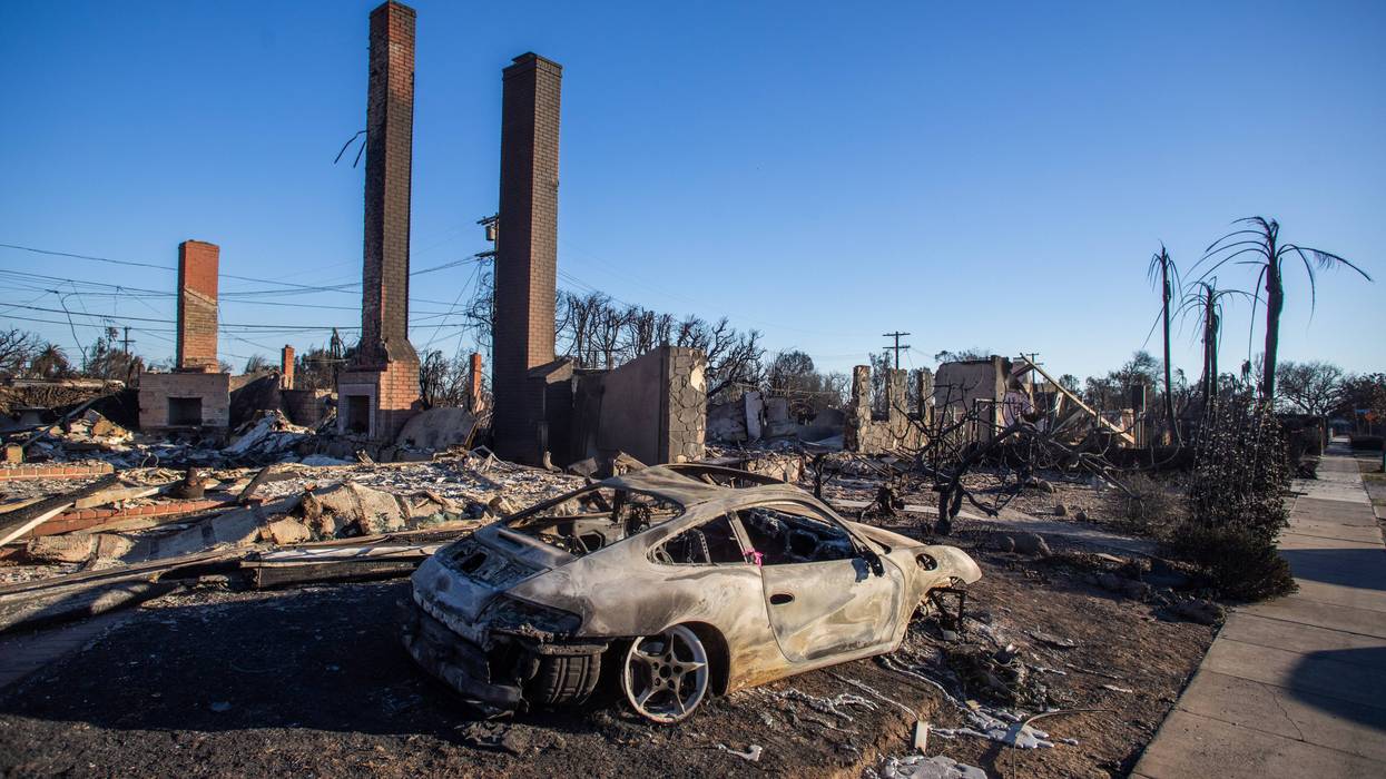 A car and homes burned by the Palisades Fire are seen on January 12, 2025 in the Pacific Palisades neighborhood of Los Angeles, California.