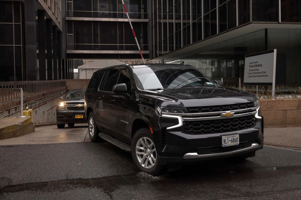 A car carrying Border Czar Tom Homan drives out of the Federal Plaza, Thursday, Feb. 13, 2025, in New York