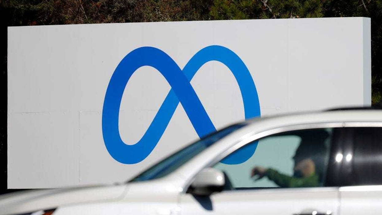 A car drives by a new logo and the name 'Meta' on the sign in front of Facebook headquarters on October 28, 2021 in Menlo Park, California.