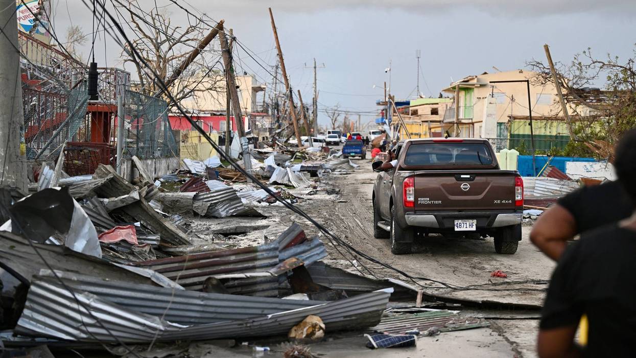 A car drives through a destroyed neighborhood following the passage of Hurricane Melissa in Black River, Jamaica, Oct. 29, 2025.