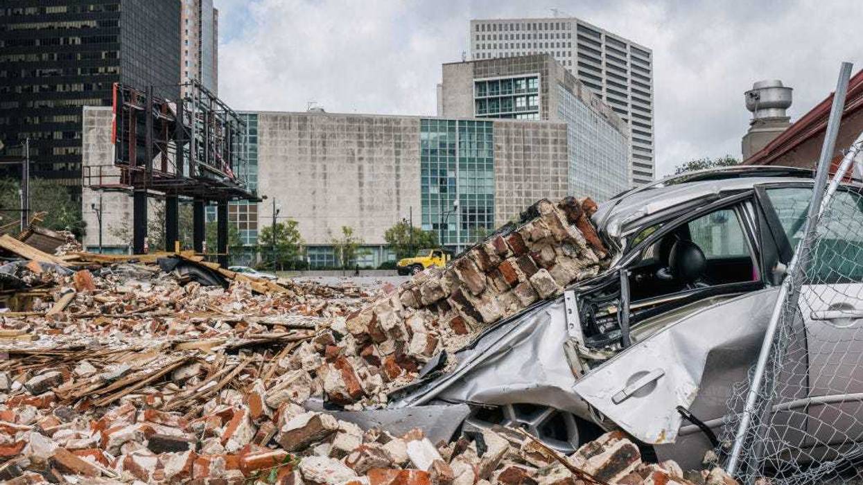A car is seen under rubble after a building was destroyed by Hurricane Ida on August 30, 2021 in New Orleans, Louisiana. Ida made landfall as a Category 4 hurricane on August 29 in Louisiana and brought flooding and wind damage along the Gulf Coast.