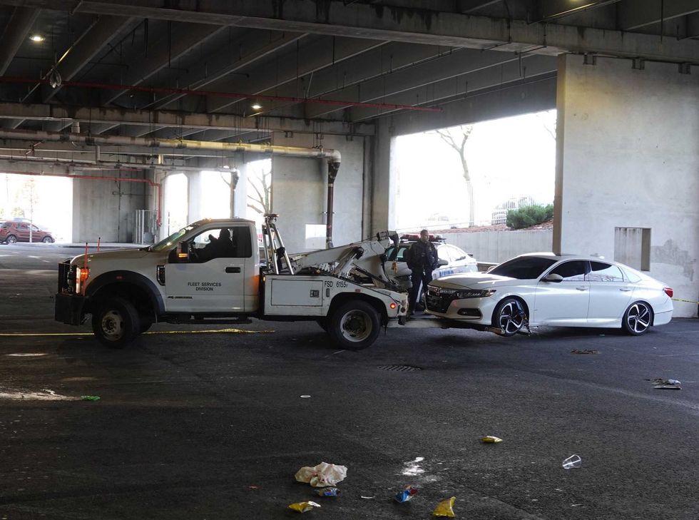 A car is towed away from the parking garage on Monday