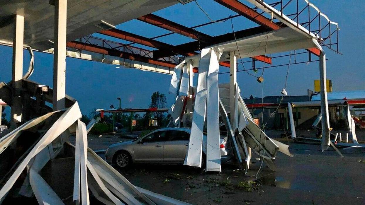 A car is trapped under the fallen metal roof of the Break Time gas station and convenience store in tornado-hit Jefferson City, MO.,