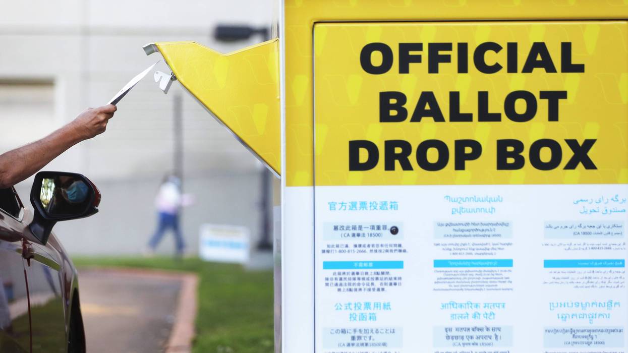 A car passenger places a ballot in an official mail-in ballot drop box outside of the L.A. County Registrar’s office ahead of Election Day on October 14, 2020 in Norwalk, California.